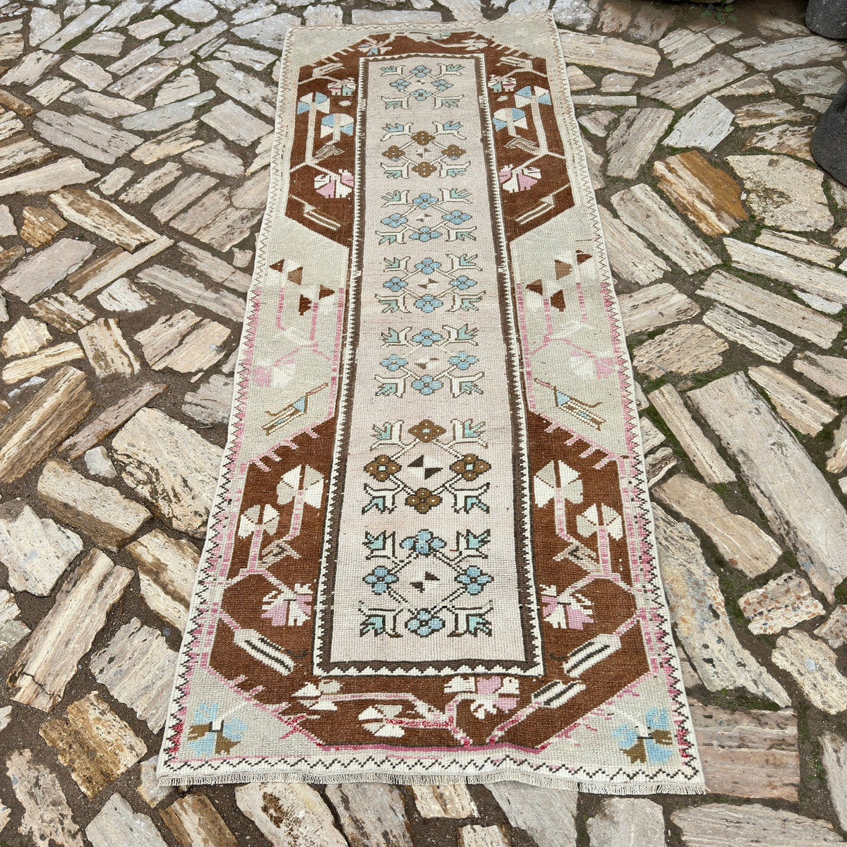Pale Pink 3' x 8' vintage turkish runner rug in wool and cotton, shown on the floor.