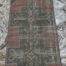 Pink 3' x 8' vintage turkish runner rug in wool and cotton, shown on the floor.