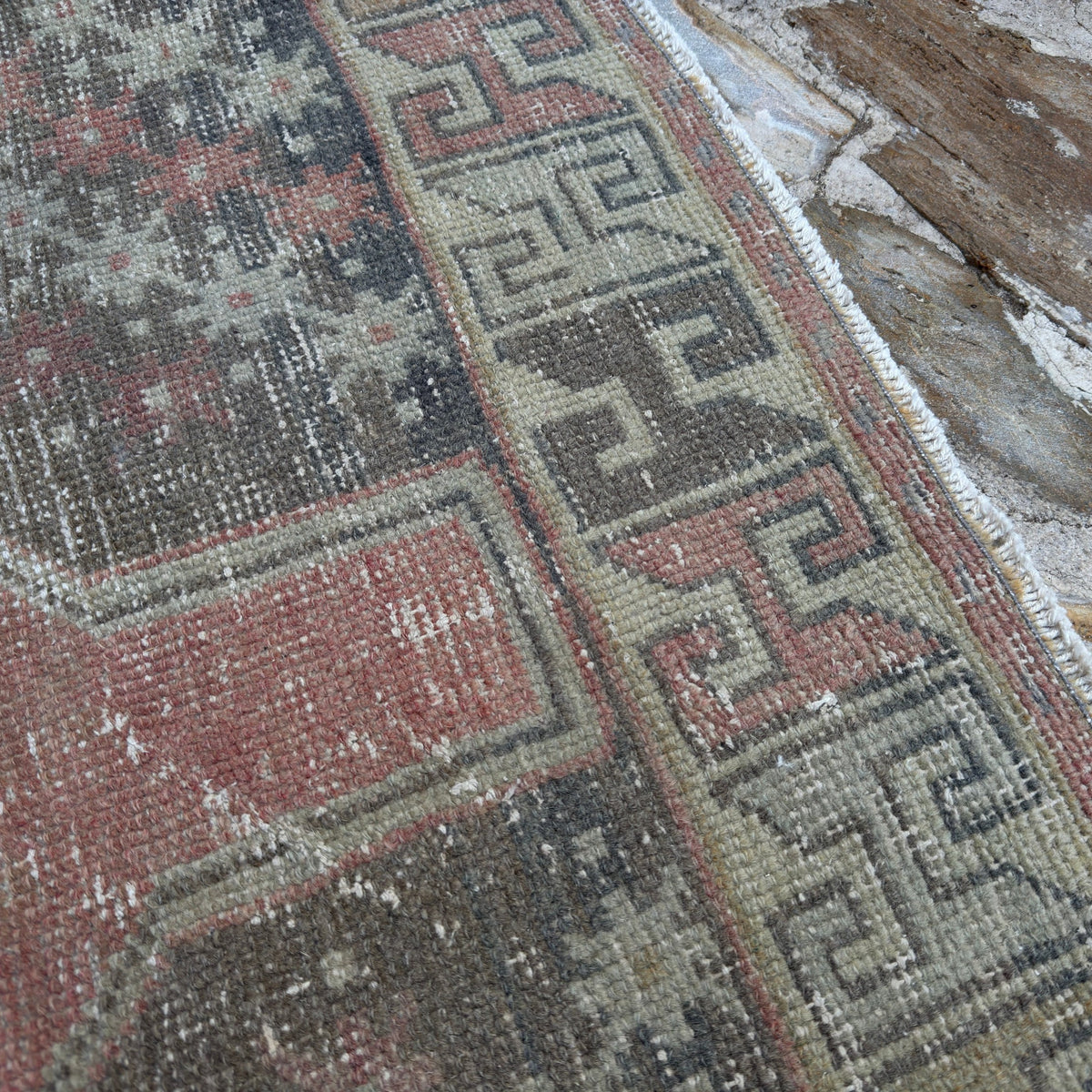 1970s pink vintage turkish runner rug with geometric design, hand-knotted weave and low pile.