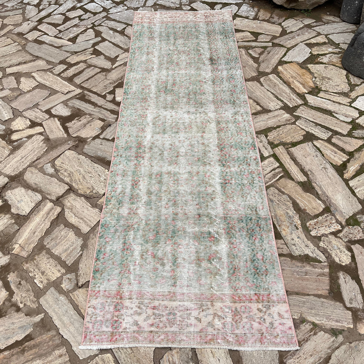 Green 3' x 9' vintage turkish runner rug in wool and cotton, shown on the floor.