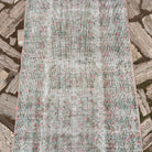 1970s green vintage turkish runner rug with floral design, hand-knotted weave and low pile.