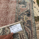 Close-up of the red vintage turkish runner rug showing traditional details, hand-knotted weave, wool and cotton and low pile.
