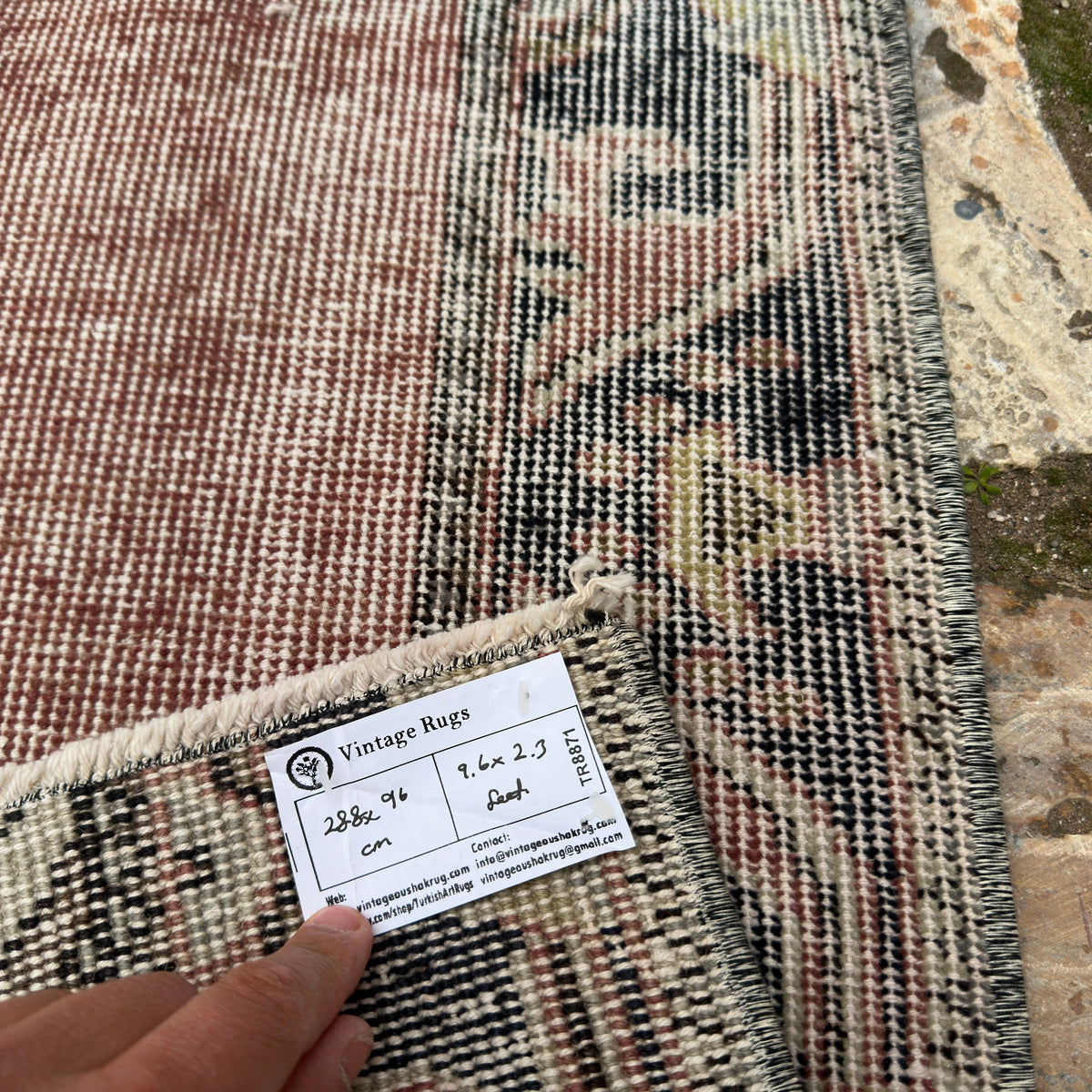 Close-up of the red vintage turkish runner rug showing traditional details, hand-knotted weave, wool and cotton and low pile.
