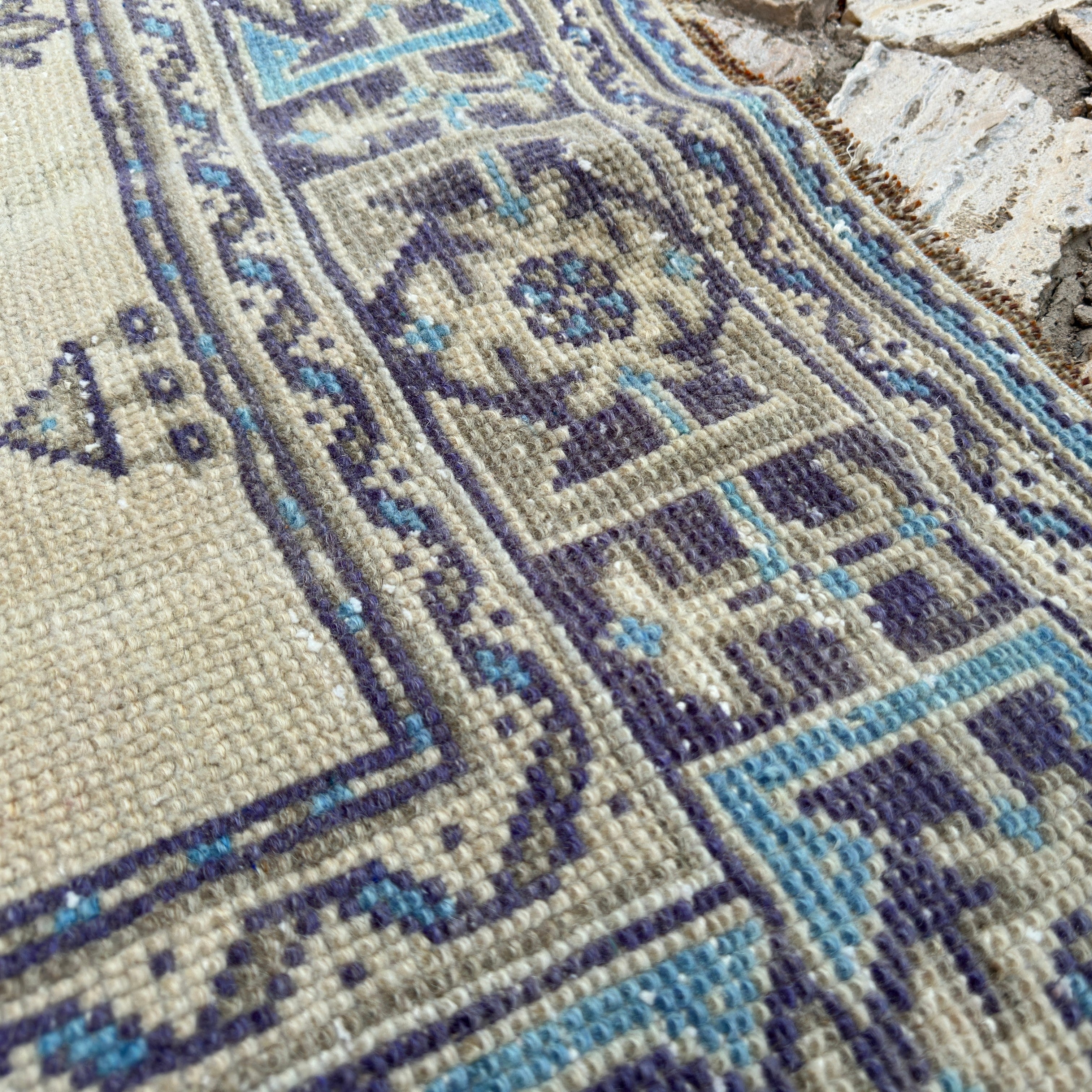 Close-up of the blue vintage turkish runner rug showing traditional details, hand-knotted weave, wool and cotton and low pile.