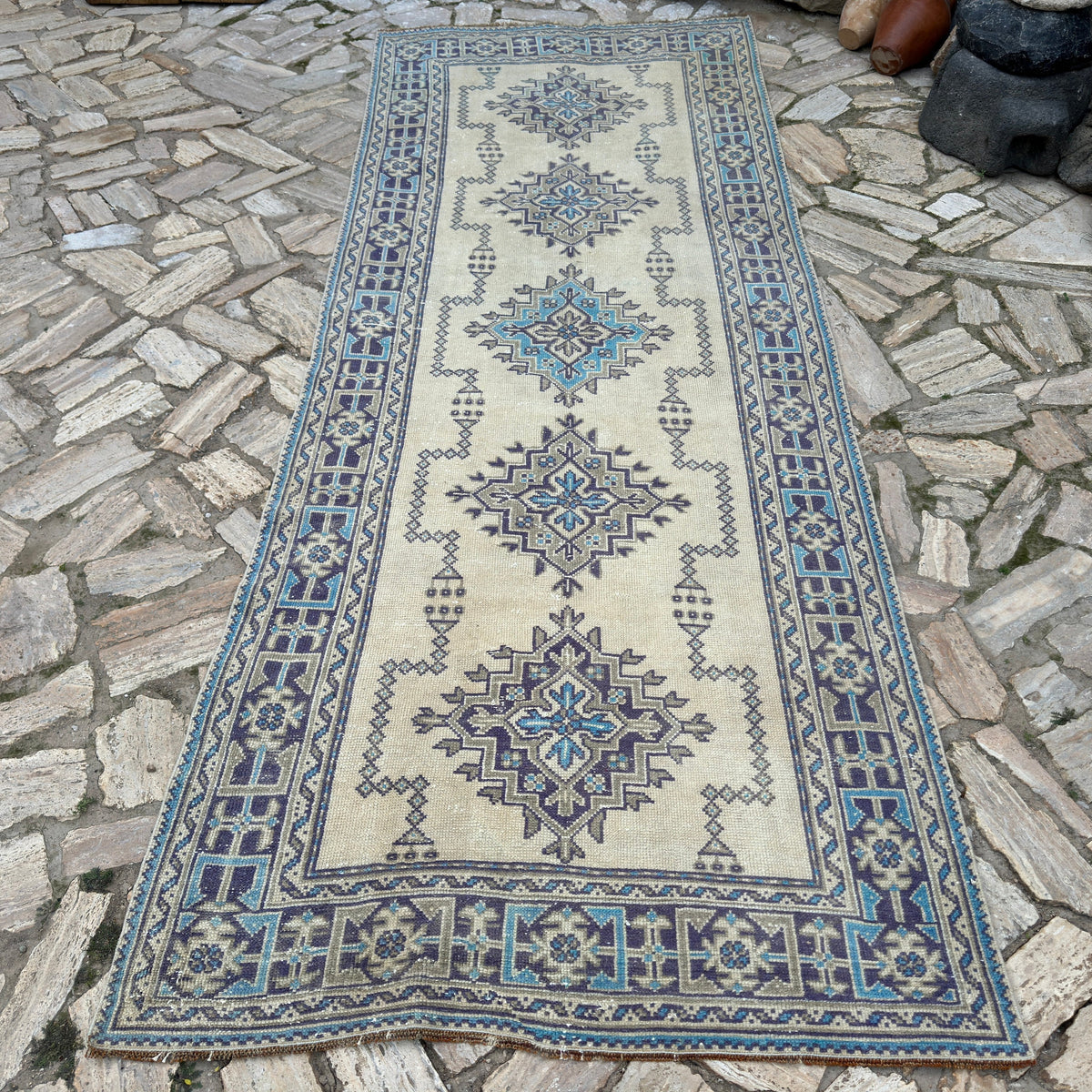 Blue 4' x 11' vintage turkish runner rug in wool and cotton, shown on the floor.