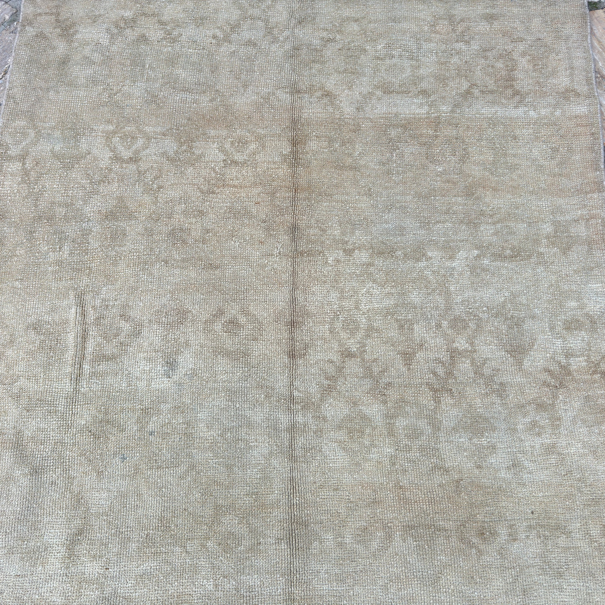 1970s brown vintage turkish runner rug with neutral design, hand-knotted weave and low pile.