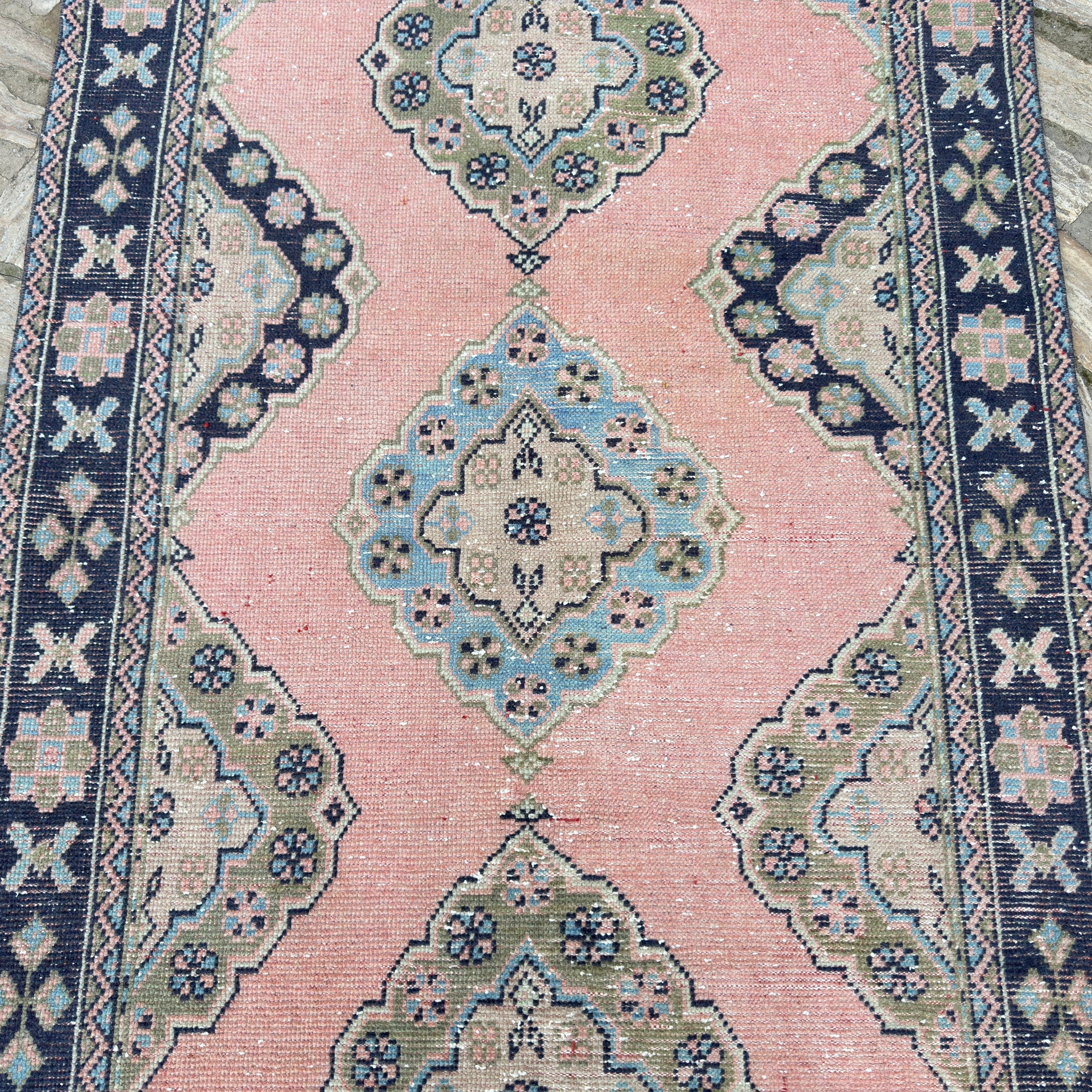 1970s pink vintage turkish runner rug with traditional design, hand-knotted weave and low pile.