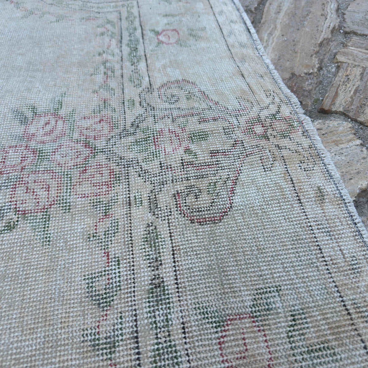 Close-up of the beige vintage turkish runner rug showing medallion details, hand-knotted weave, wool and cotton and low pile.