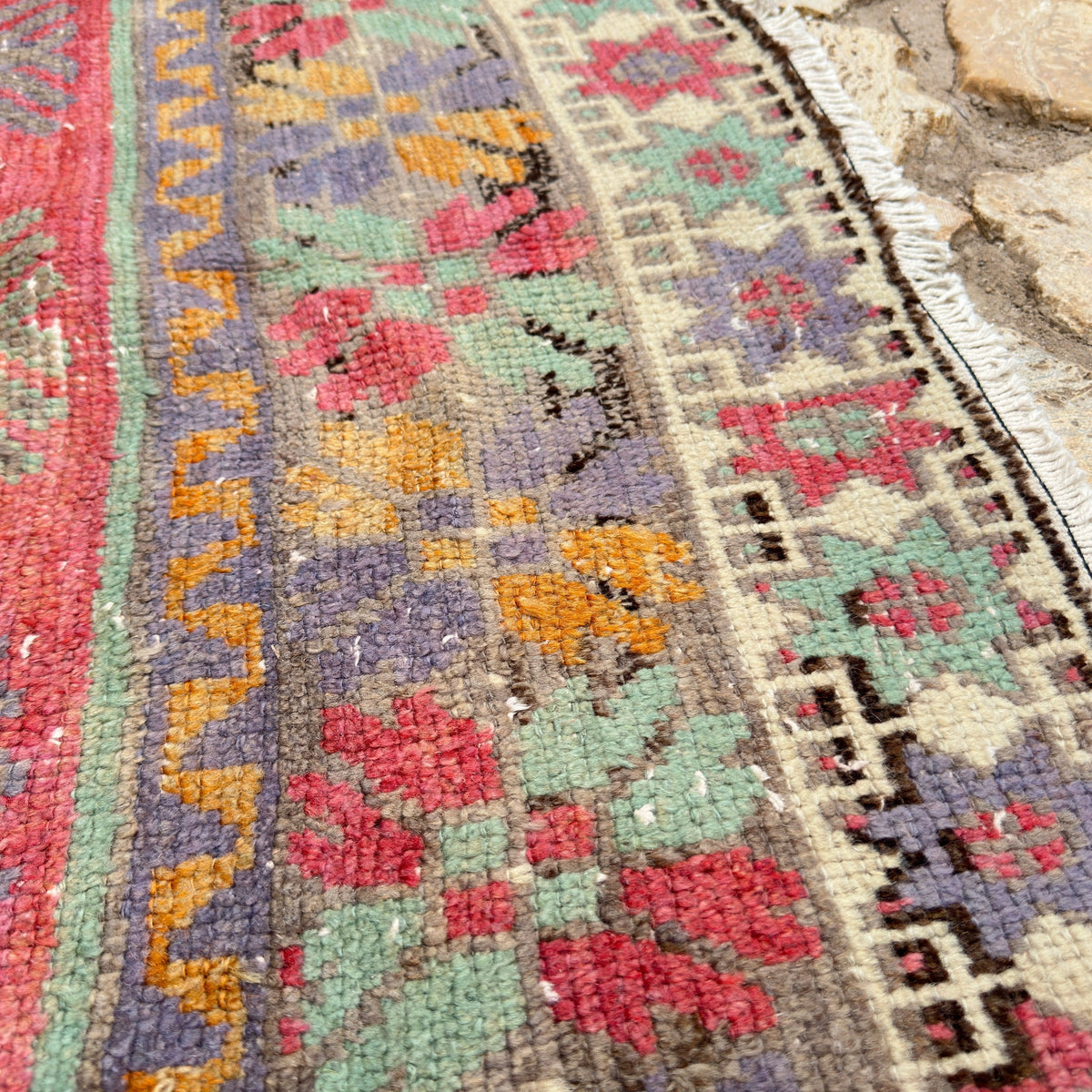 Close-up of the green vintage turkish runner rug showing geometric details, flatweave construction, wool and cotton and low pile.