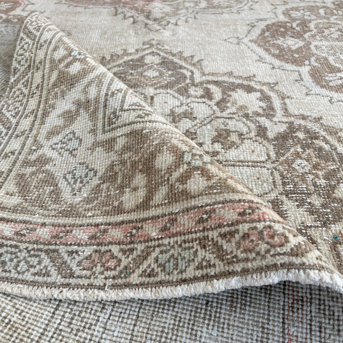 1970s brown vintage turkish runner rug with neutral design, hand-knotted weave and low pile.