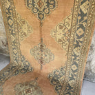 Orange 5' x 13' vintage turkish runner rug in wool and cotton, shown on the floor.