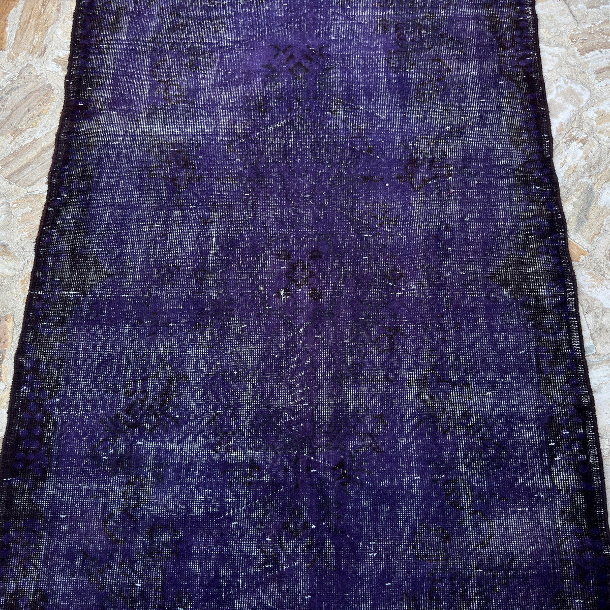 Purple 4' x 7' vintage Turkish wool overdyed rug in wool and cotton, shown on the floor.
