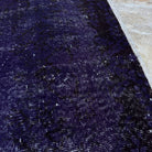 1970s purple vintage Turkish wool overdyed rug with overdyed design, hand-knotted weave and low pile.