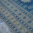 Blue 3' x 4' vintage Turkish wool rug in wool, shown on the floor.