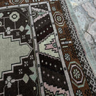 Close-up of the brown vintage Turkish wool rug showing traditional details, hand-knotted weave, wool and cotton and low pile.