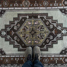 1970s brown vintage Turkish wool rug with traditional design, hand-knotted weave and low pile.