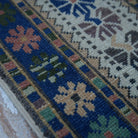 Blue 4' x 6' vintage Turkish wool rug in wool, shown on the floor.