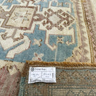 Close-up of the pale red vintage Turkish wool rug showing traditional details, hand-knotted weave, wool and cotton and low pile.