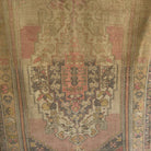 Pink 4' x 6' vintage Turkish wool rug in wool and cotton, shown on the floor.