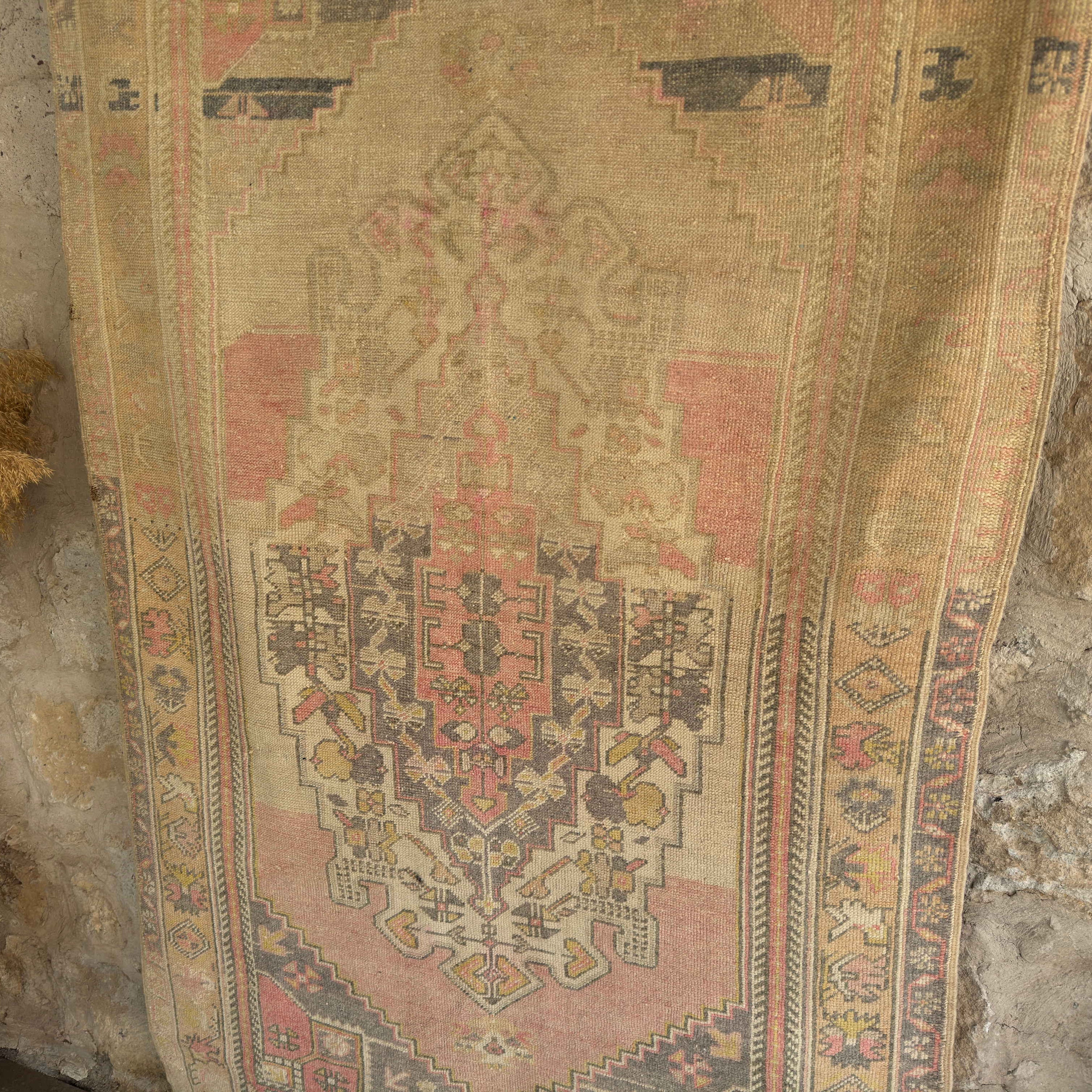 1970s pink vintage Turkish wool rug with neutral design, hand-knotted weave and low pile.