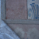 1970s pink vintage Turkish wool rug with geometric design, hand-knotted weave and low pile.