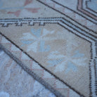 Beige 4' x 7' vintage Turkish wool rug in wool, shown on the floor.