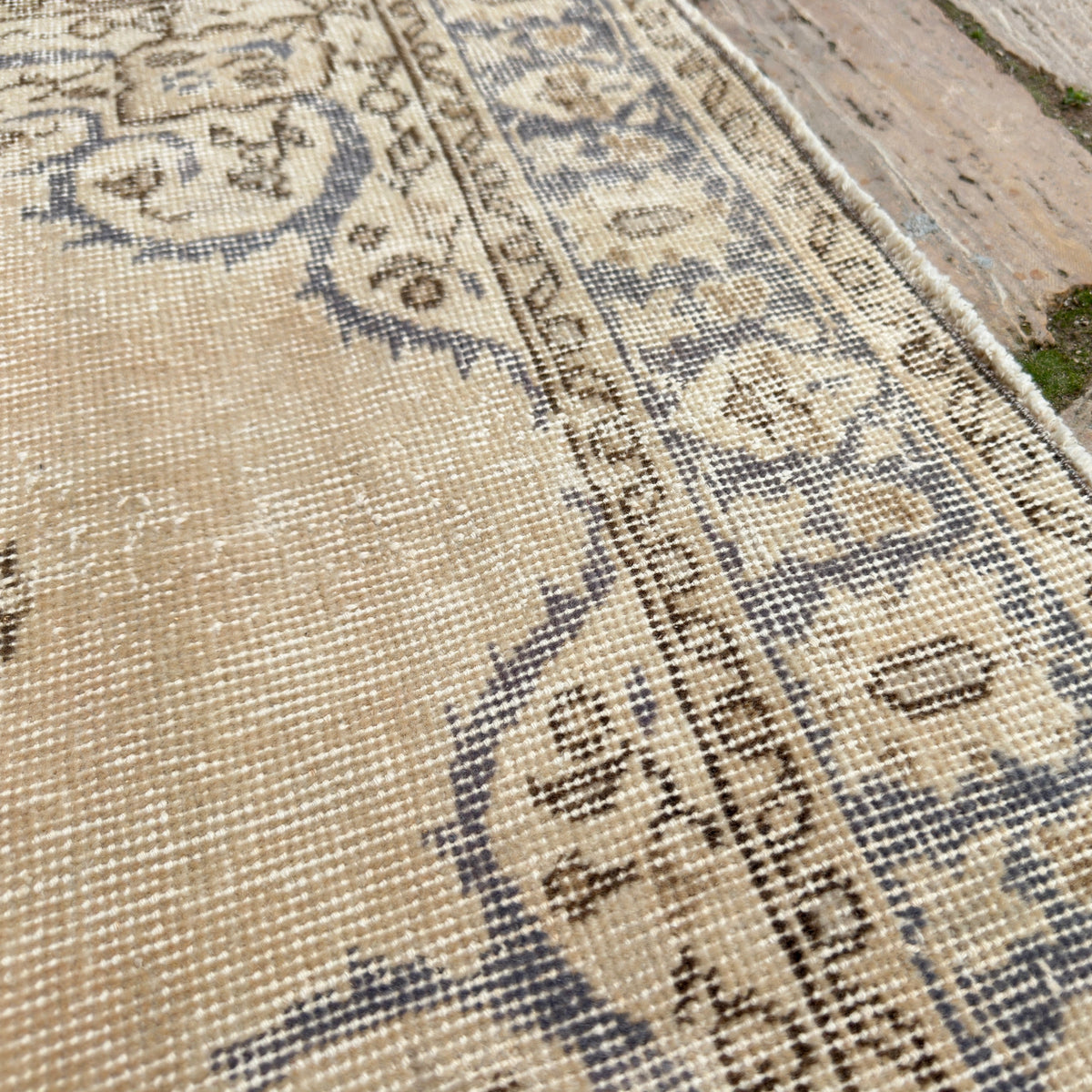 Close-up of the blue vintage Turkish wool rug showing medallion details, hand-knotted weave, wool and cotton and low pile.