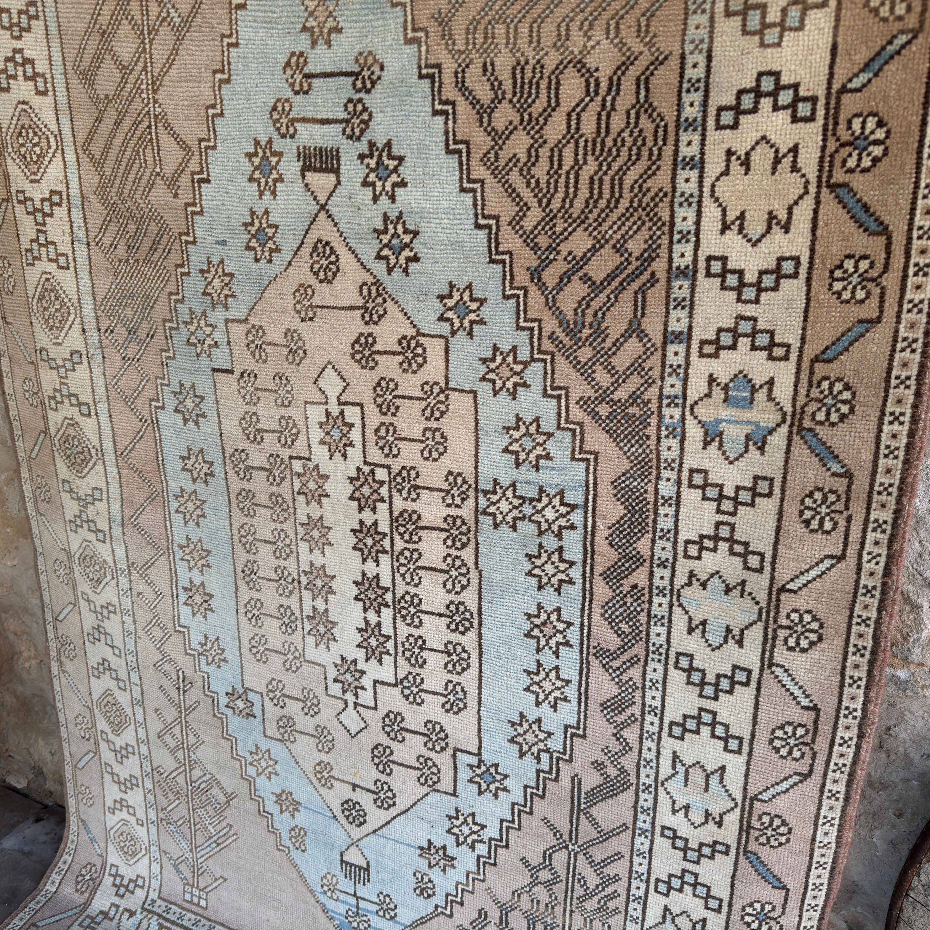 Blue 4' x 7' vintage Turkish wool rug in wool and cotton, shown on the floor.