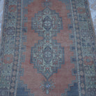 Close-up of the orange vintage Turkish wool rug showing traditional details, hand-knotted weave, wool and low pile.