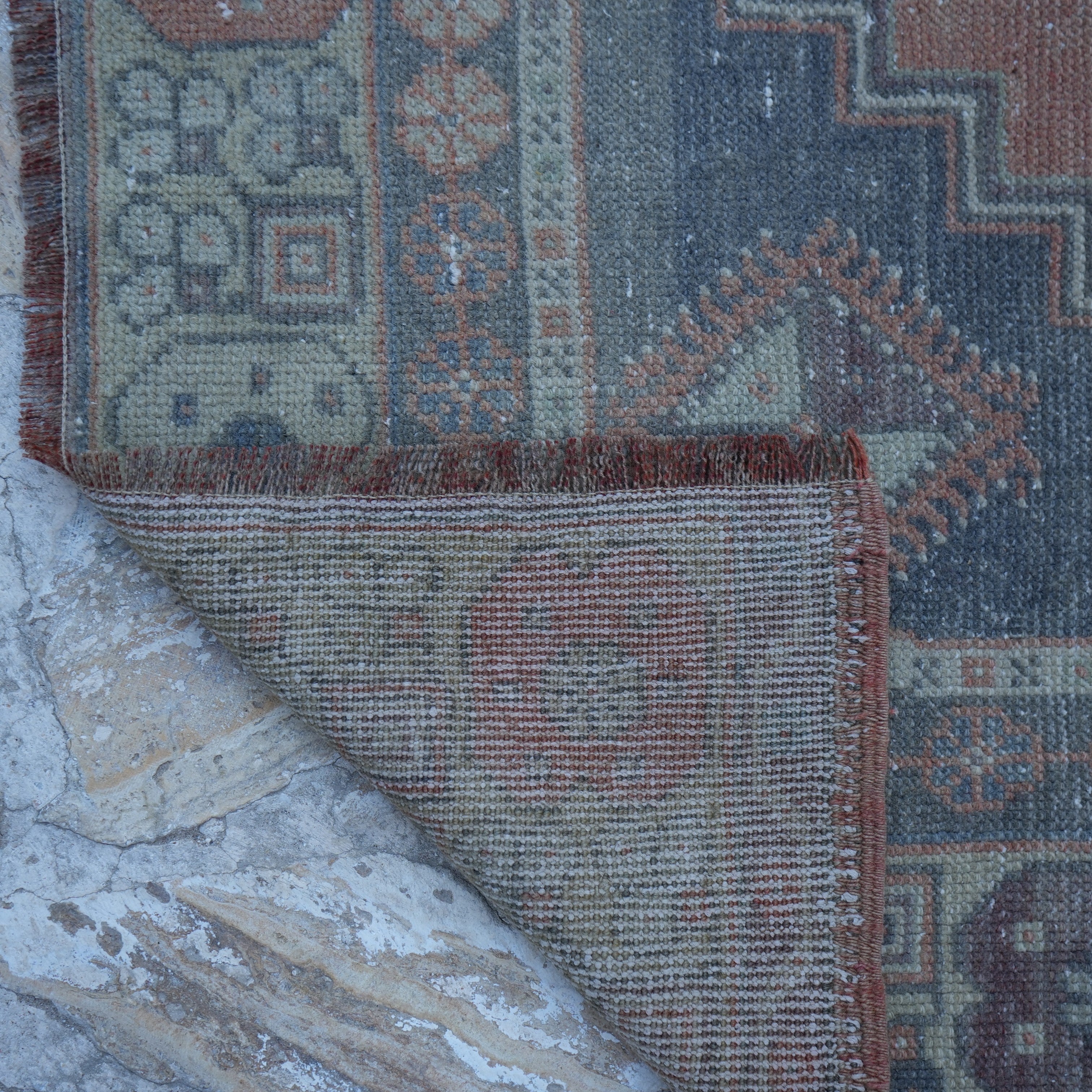 1970s orange vintage Turkish wool rug with traditional design, hand-knotted weave and low pile.