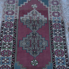 Close-up of the pale purple vintage Turkish wool rug showing traditional details, hand-knotted weave, wool and low pile.