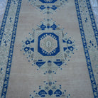Close-up of the blue vintage Turkish wool rug showing medallion details, hand-knotted weave, wool and low pile.
