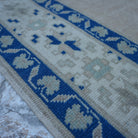 Pale Pink 5' x 11' vintage Turkish wool rug in wool, shown on the floor.