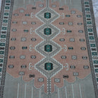 Close-up of the beige vintage Turkish wool rug showing geometric details, hand-knotted weave, wool and low pile.