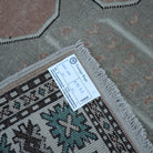 Beige 5' x 7' vintage Turkish wool rug from the 1970s with geometric design.
