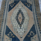 Close-up of the blue vintage Turkish wool rug showing neutral details, hand-knotted weave, wool and low pile.