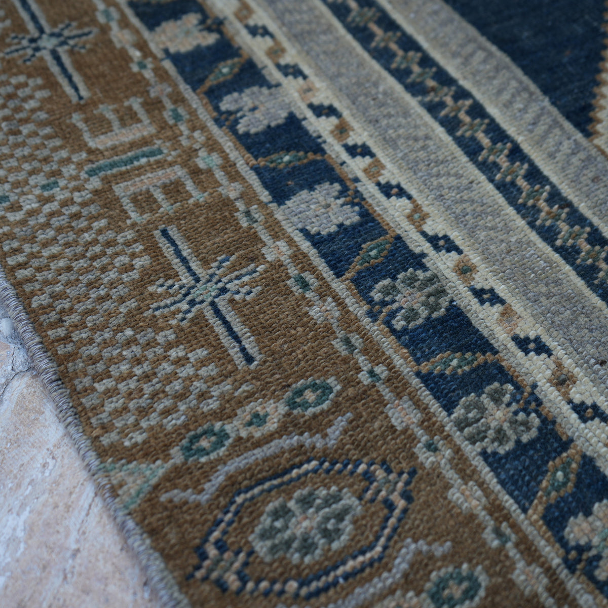 Blue 5' x 7' vintage Turkish wool rug in wool, shown on the floor.