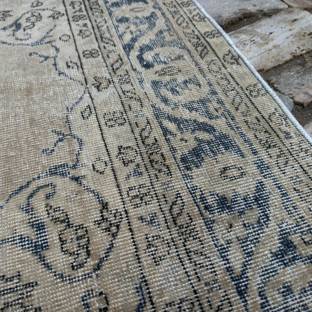 Close-up of the blue vintage Turkish wool rug showing medallion details, hand-knotted weave, wool and cotton and low pile.