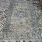 Blue 5' x 8' vintage Turkish wool rug in wool and cotton, shown on the floor.