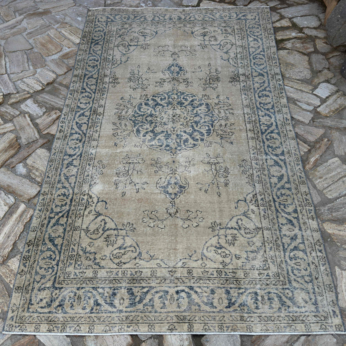 Blue 5' x 8' vintage Turkish wool rug in wool and cotton, shown on the floor.