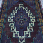 Close-up of the purple vintage Turkish wool rug showing traditional details, hand-knotted weave, wool and low pile.