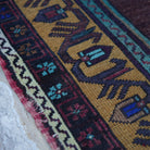 Purple 5' x 9' vintage Turkish wool rug in wool, shown on the floor.