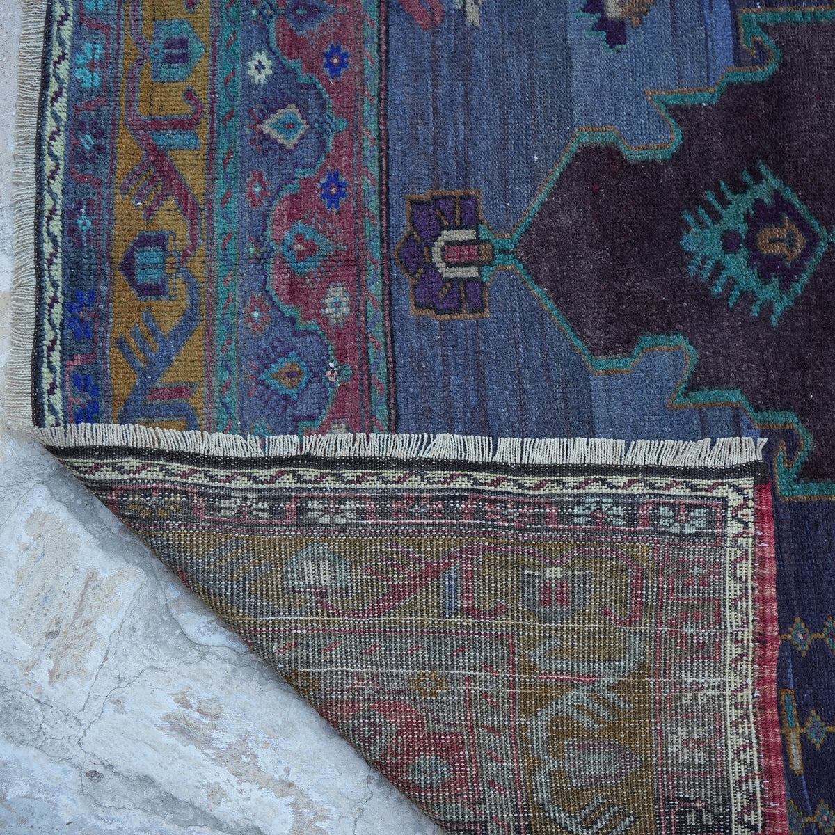 1970s purple vintage Turkish wool rug with traditional design, hand-knotted weave and low pile.