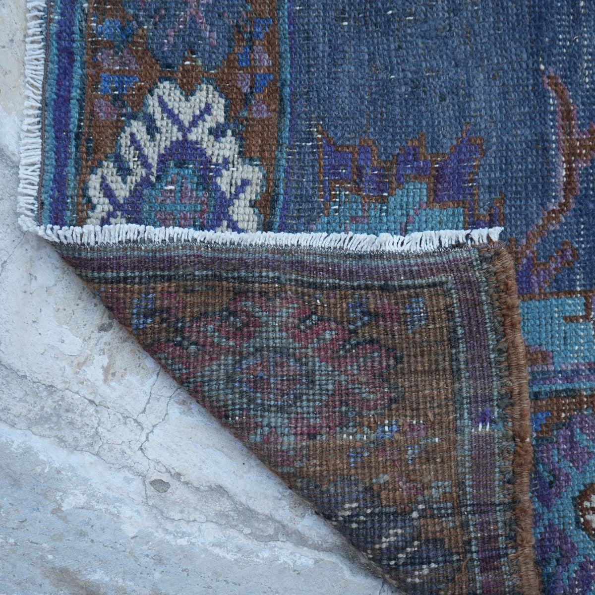 1970s purple vintage Turkish wool rug with traditional design, hand-knotted weave and low pile.