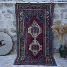 Red 5' x 9' vintage wool rug with traditional design, handmade in Turkey – Jayce.