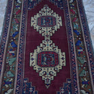 Close-up of the red vintage Turkish wool rug showing traditional details, hand-knotted weave, wool and low pile.