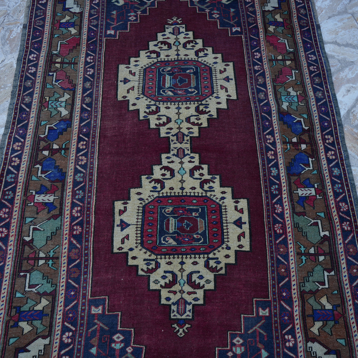 Close-up of the red vintage Turkish wool rug showing traditional details, hand-knotted weave, wool and low pile.
