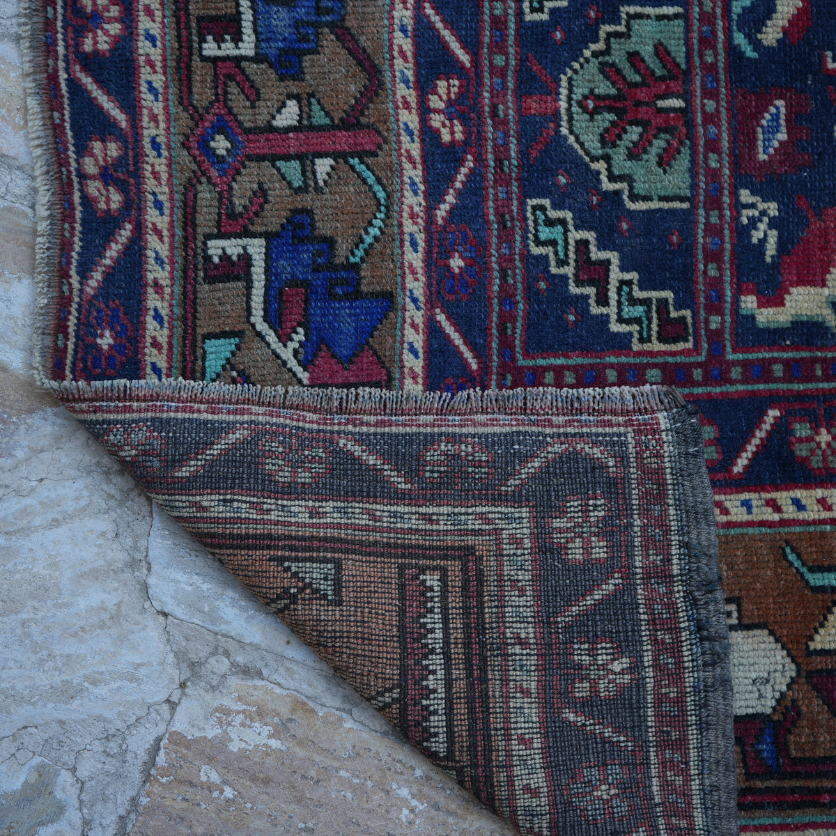 1970s red vintage Turkish wool rug with traditional design, hand-knotted weave and low pile.