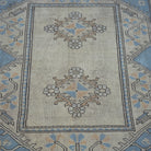 Close-up of the pale blue vintage Turkish wool rug showing geometric details, hand-knotted weave, wool and low pile.