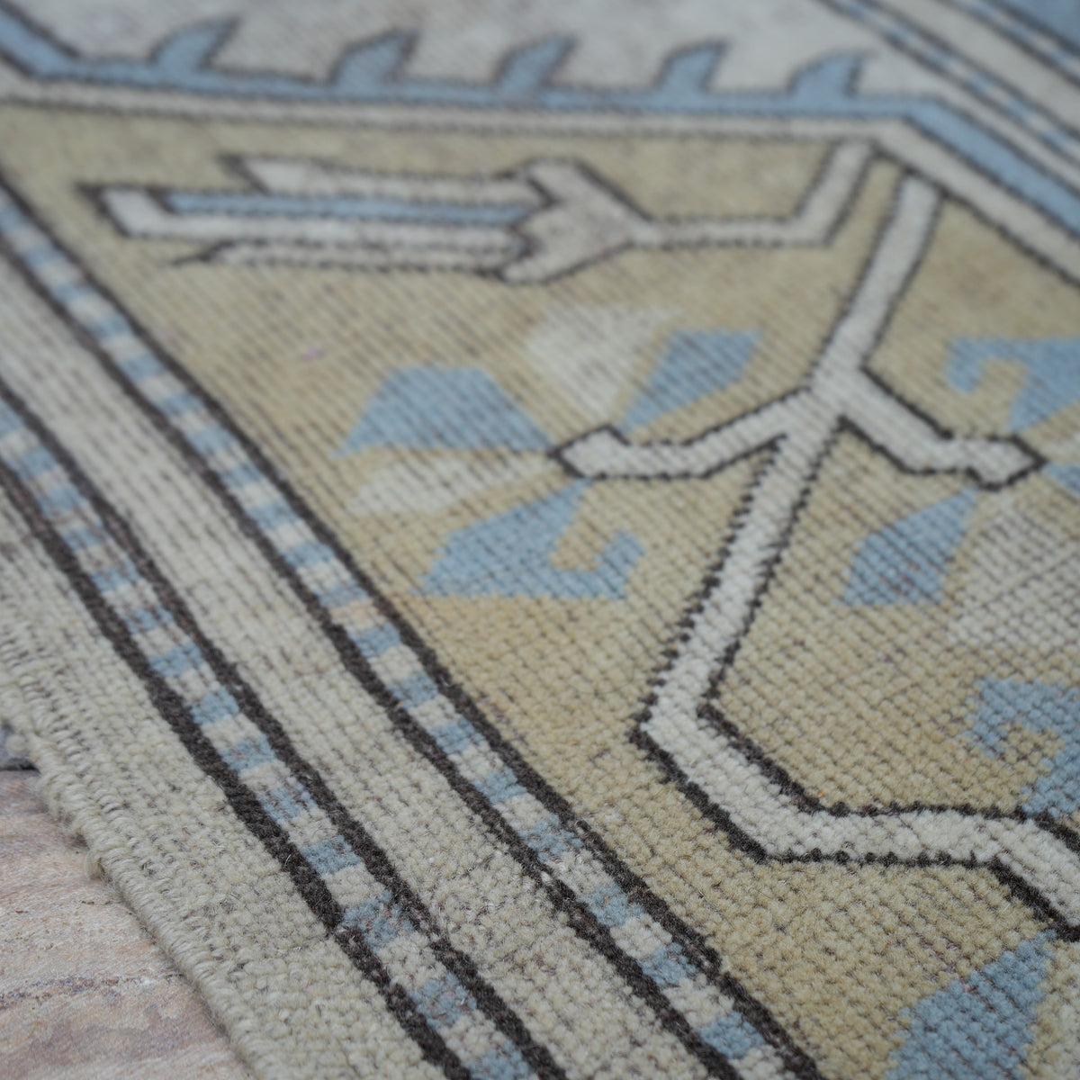 Pale Blue 6' x 7' vintage Turkish wool rug in wool, shown on the floor.